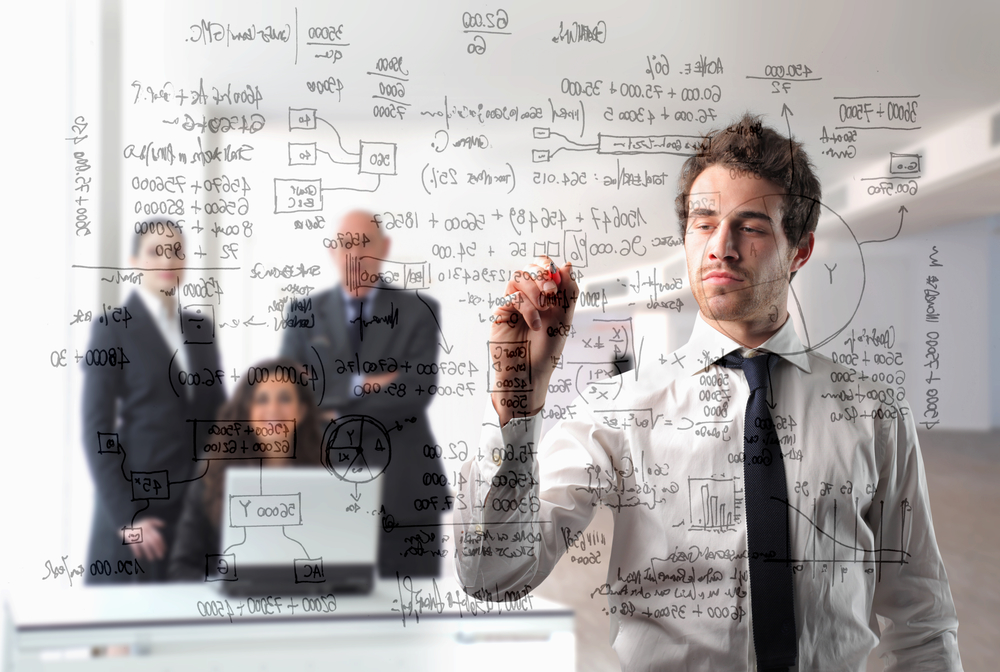 Businessman writing some schemes with group of business people on the background