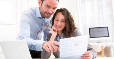 View of a Young attractive couple doing paperwork