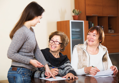 Portrait of positive mature women with papers and agency employee