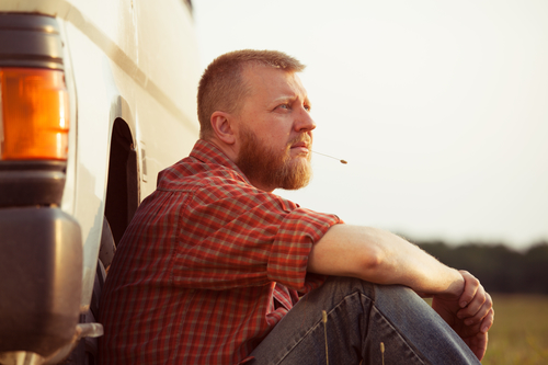 Red-bearded man in jeans on a summer evening