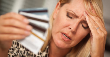 Very Upset Woman Holding Her Many Credit Cards.