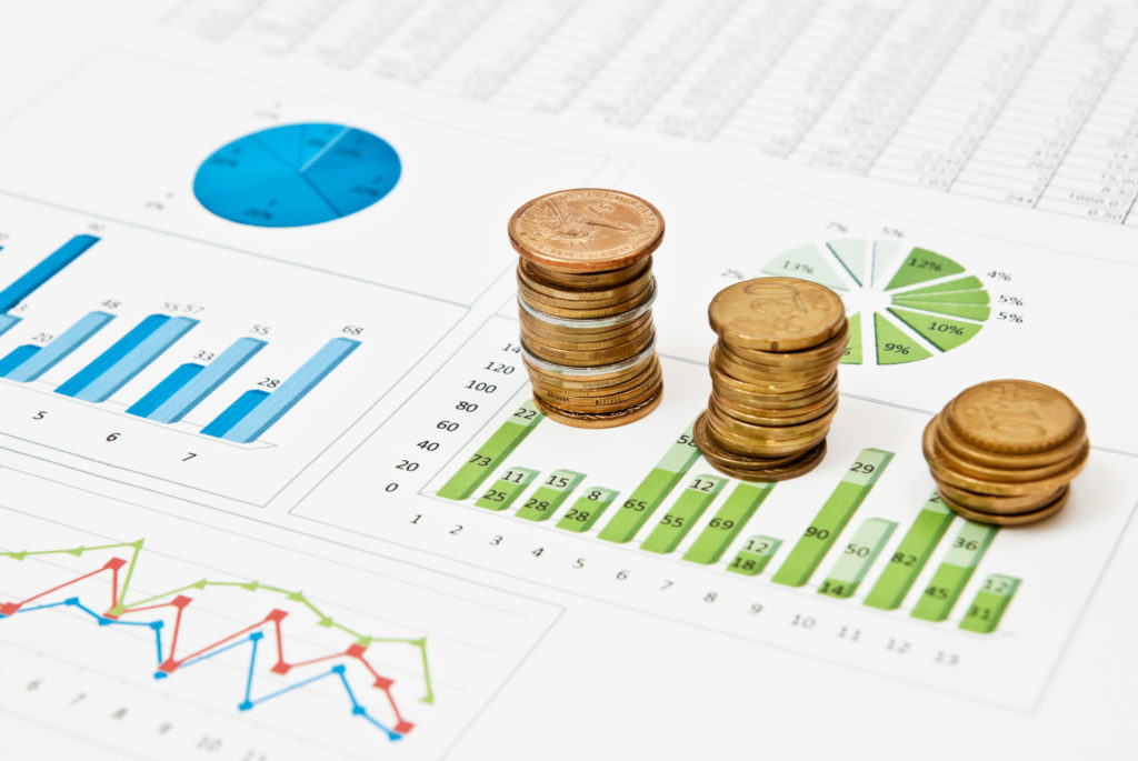 Graphs and charts with stacks of coins