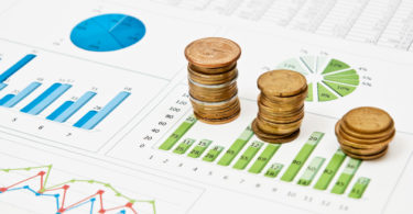 Graphs and charts with stacks of coins