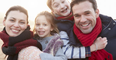 Portrait Of Family On Winter Beach