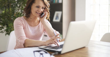 Busy businesswoman working at home office