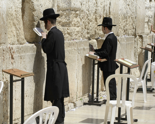 jewish men praying at the wailing wall, jerusalem, israel