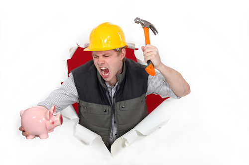 Tradesman about to smash a piggy bank