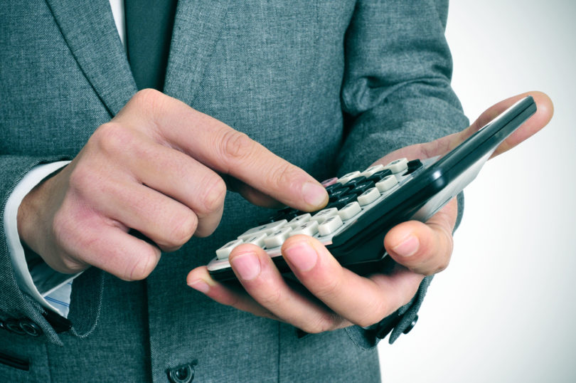 a businessman using a calculator