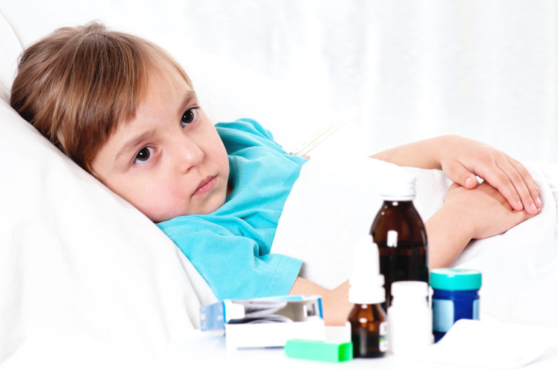 Sick little beautiful girl with red scarf in the bed