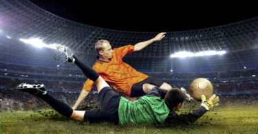 Football player and jump of goalkeeper on the field of stadium at night