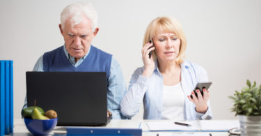 Elderly businesswoman working and talking on the phone