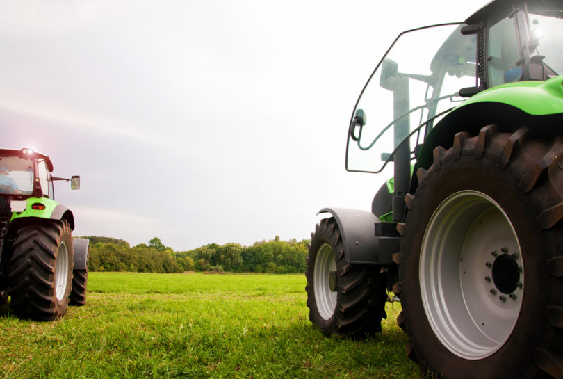 two tractors on the green field