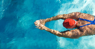 Athletic swimmer in action in a swimming pool