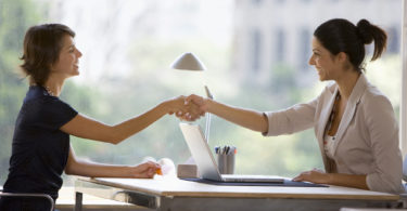 Businesswomen shaking hands