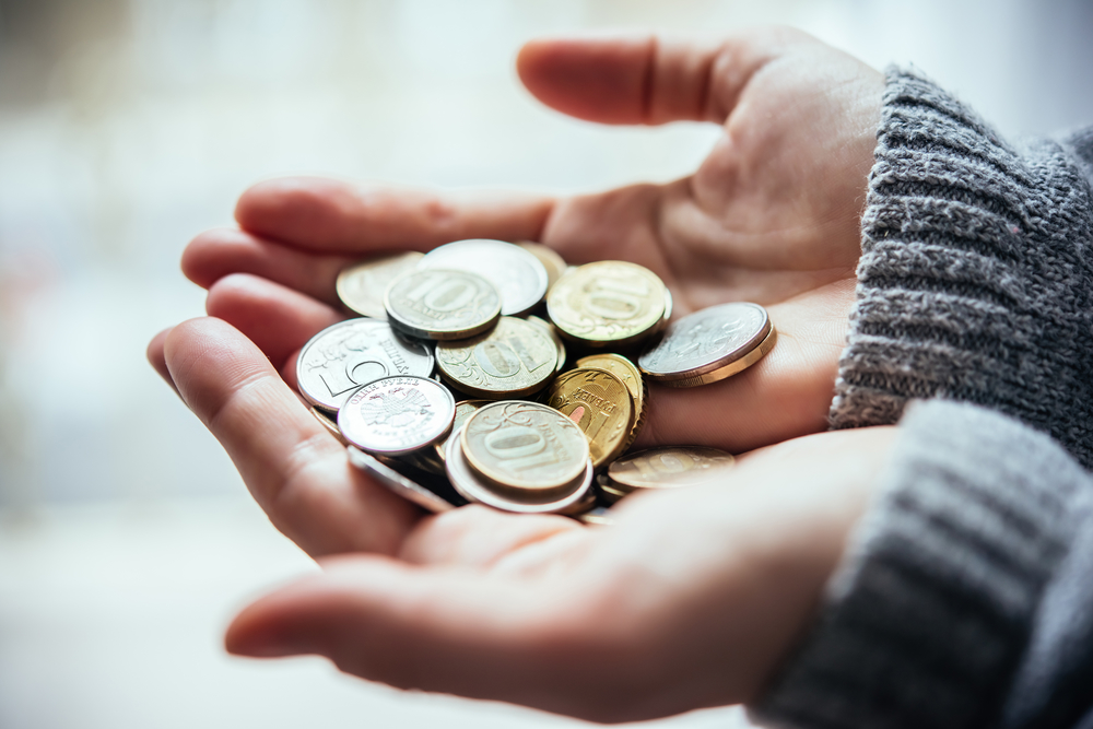 Hands holding russian rouble coins in hands