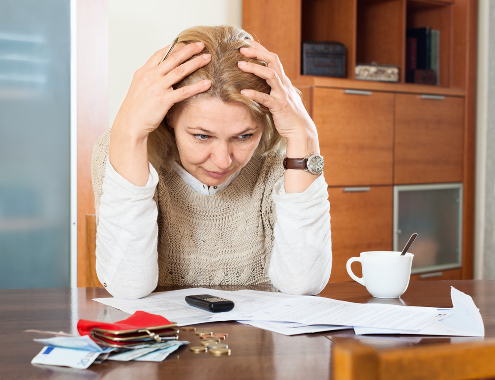 mature woman thinking about family budget at home