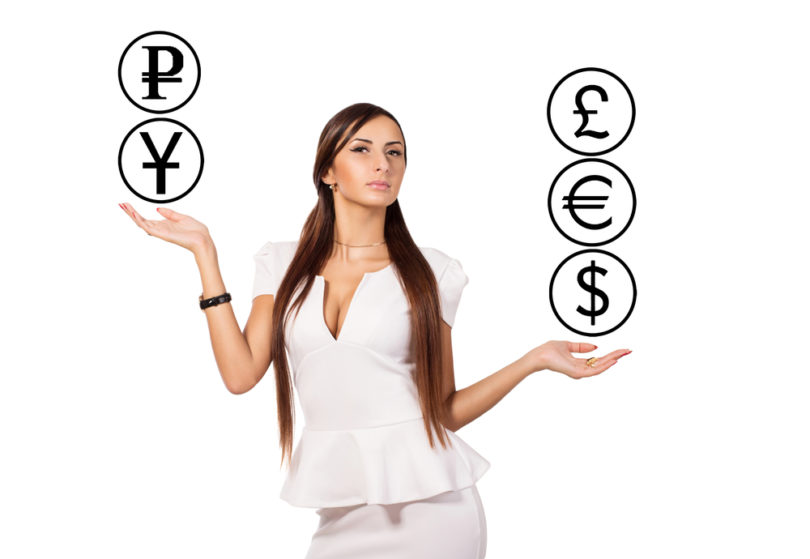 Modern young business woman standing and currency manipulation. Businesswoman juggling. Active business lady dressed in white. White background. Businesswoman holding hands on the similarity scales.