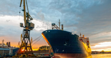 Cargo ship in the harbor at sunset. Gdansk, Poland.