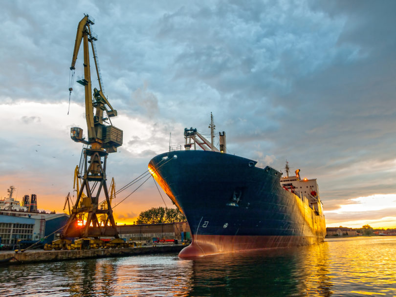 Cargo ship in the harbor at sunset. Gdansk, Poland.