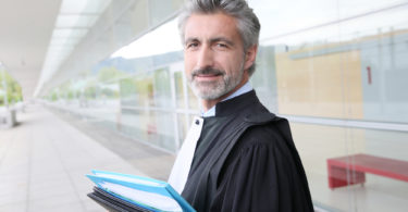 Portrait of lawyer standing outside courthouse building