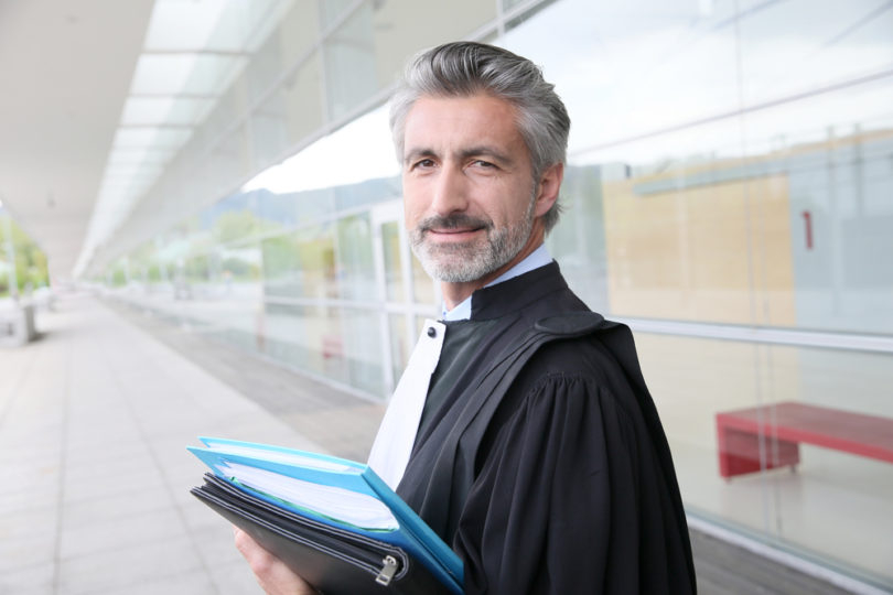 Portrait of lawyer standing outside courthouse building