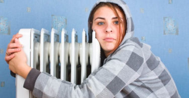 The freezing girl about a heater