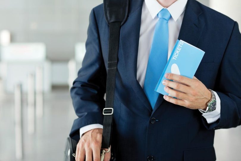 Businessman Holding Airplane Ticket At Airport