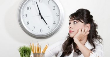 Bored woman at her desk at the end of the day